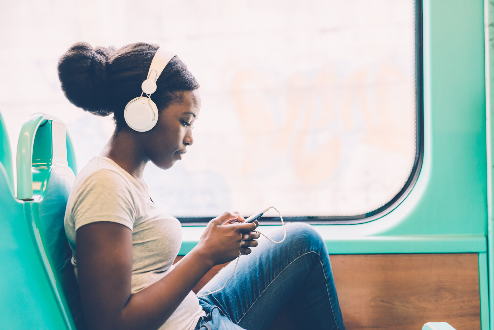 Girl on bus listening to music
