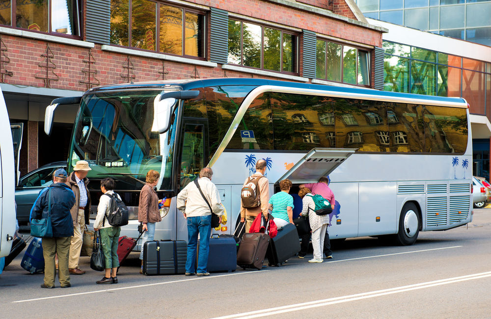 Passengers loading luggages on a bus